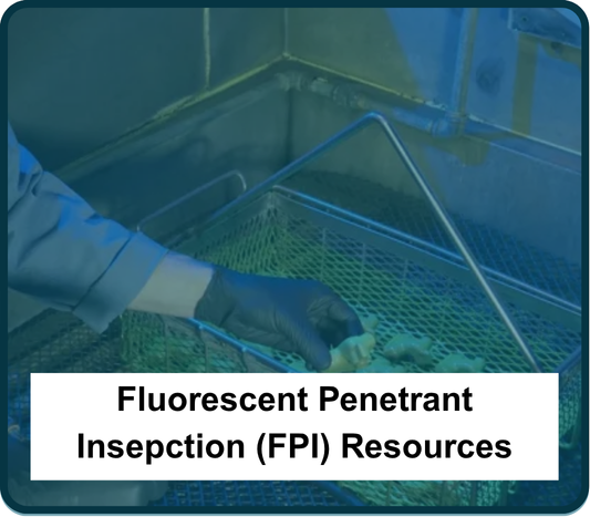 Image showing an employee conducting a Fluorescent Penetrant Inspection on metal parts.