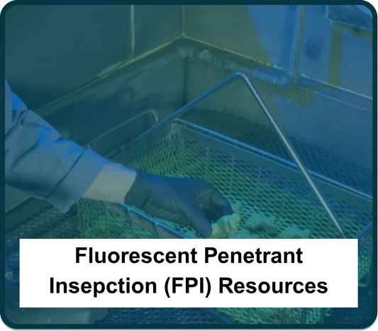 Image showing an employee conducting a Fluorescent Penetrant Inspection on metal parts.
