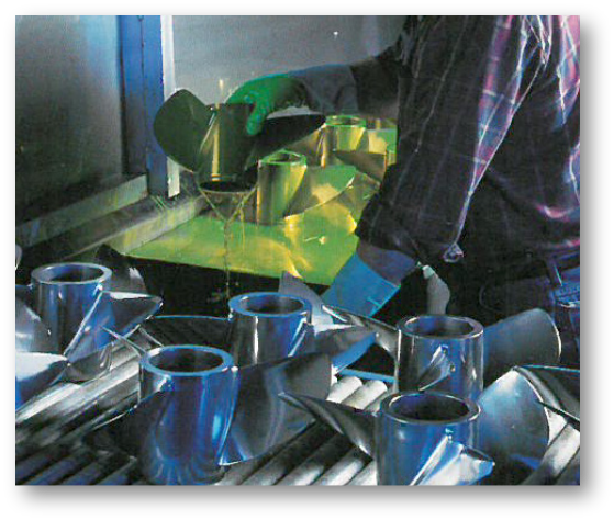 Action shot of an American Metal Testing employee NDT testing boat propellers for imperfections after they were manufactured.
